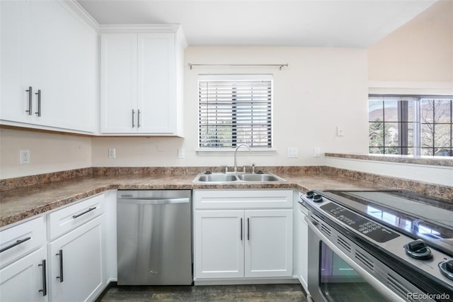 2172 Denton Grv Unit 203, Colorado Springs, CO 80919 - kitchen with white cabinets, appliances with stainless steel finishes, and a sink