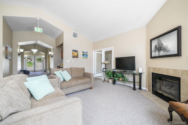 2172 Denton Grv Unit 203, Colorado Springs, CO 80919 - living room with visible vents, vaulted ceiling, a fireplace, carpet flooring, and baseboards