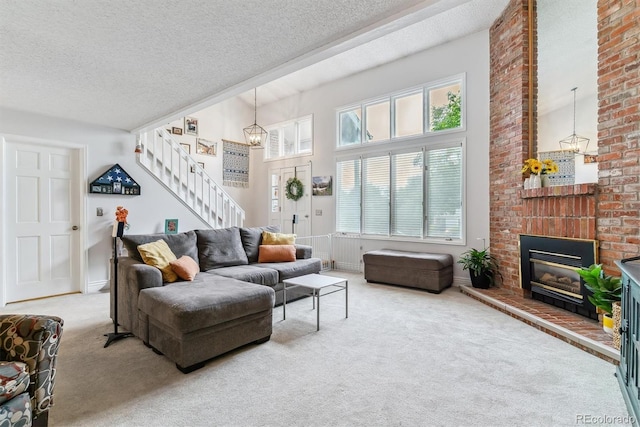 4231 S Fairplay Cir # E, Aurora, CO 80014 - living area with carpet flooring, stairway, healthy amount of natural light, and a textured ceiling