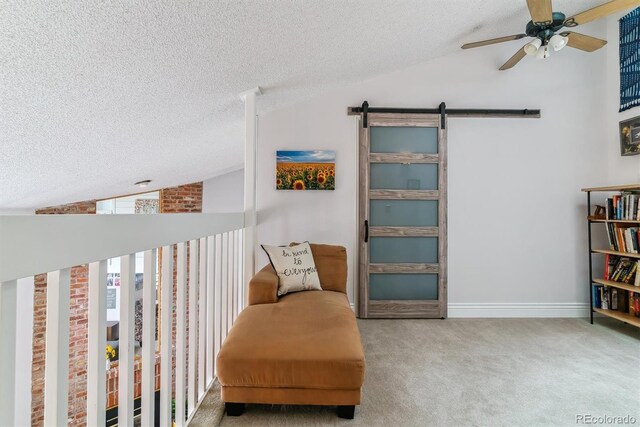 4231 S Fairplay Cir # E, Aurora, CO 80014 - living area featuring vaulted ceiling, a textured ceiling, carpet, a barn door, and ceiling fan