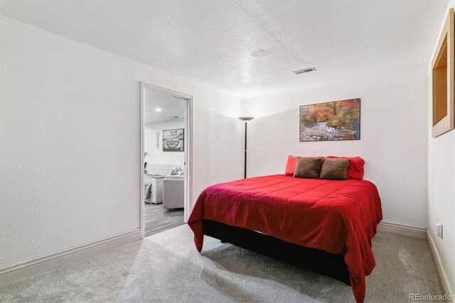 4231 S Fairplay Cir # E, Aurora, CO 80014 - bedroom featuring carpet, a textured ceiling, and baseboards