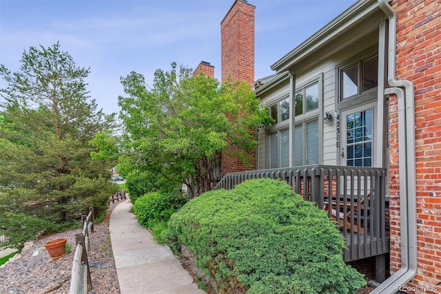 4231 S Fairplay Cir # E, Aurora, CO 80014 - view of side of property with brick siding and a chimney
