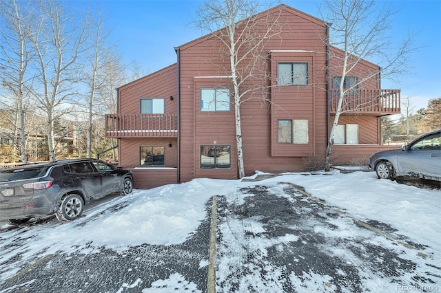 view of snow covered exterior with a balcony