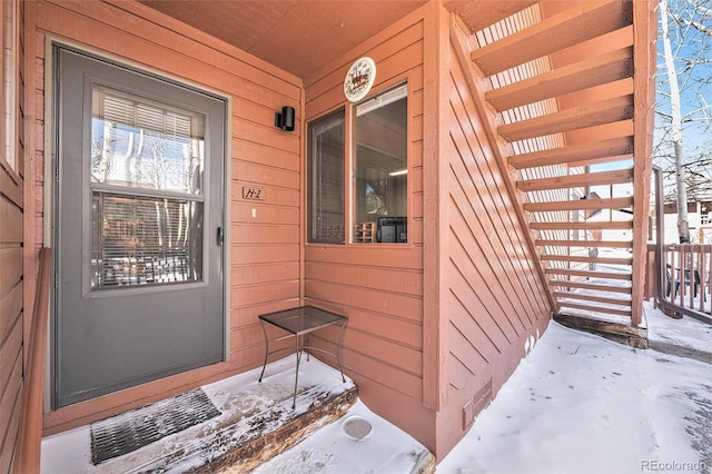 view of snow covered property entrance