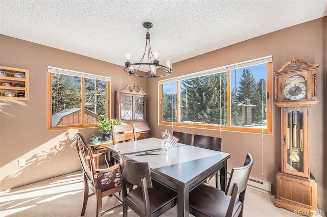 dining room with a baseboard heating unit, light carpet, a notable chandelier, and a textured ceiling