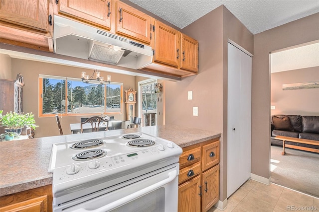 kitchen featuring light carpet, a notable chandelier, a textured ceiling, and white range with electric cooktop