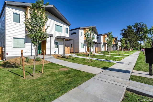 view of front of property featuring a residential view and a front yard