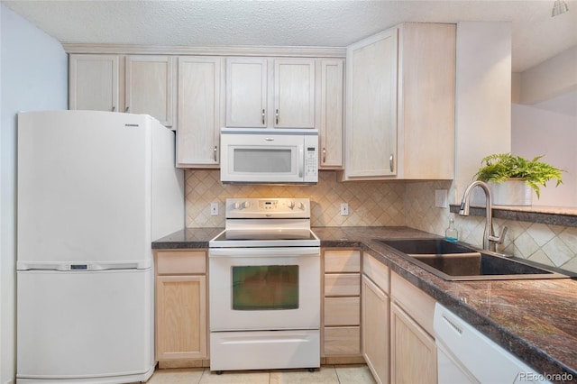 kitchen featuring sink, white appliances, light tile patterned floors, tasteful backsplash, and light brown cabinetry