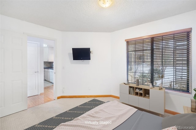 bedroom with a textured ceiling and carpet flooring