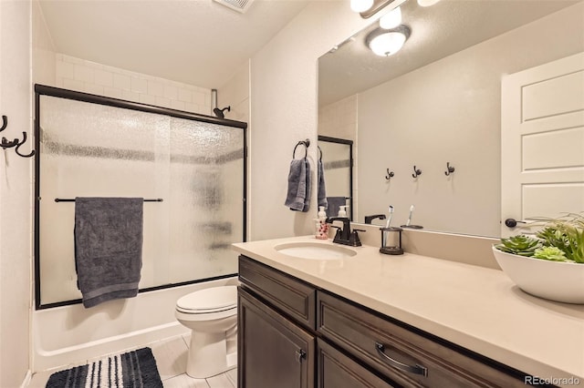 full bathroom featuring vanity, toilet, combined bath / shower with glass door, and a textured ceiling