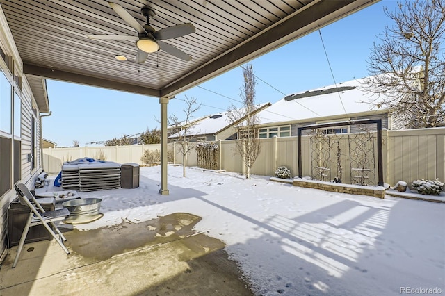 snow covered patio featuring ceiling fan