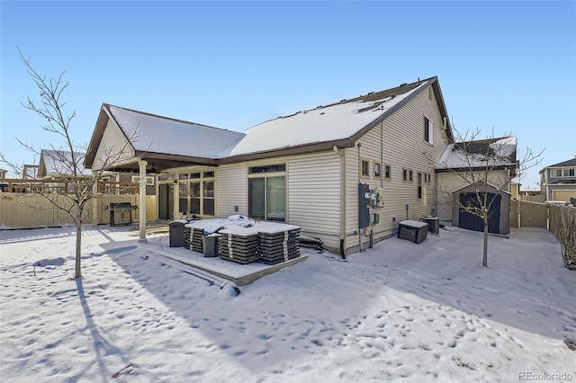 view of snow covered back of property