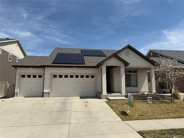 5232 Truckee St, Denver, CO 80249 - view of front of house featuring an attached garage, concrete driveway, stucco siding, and a shingled roof