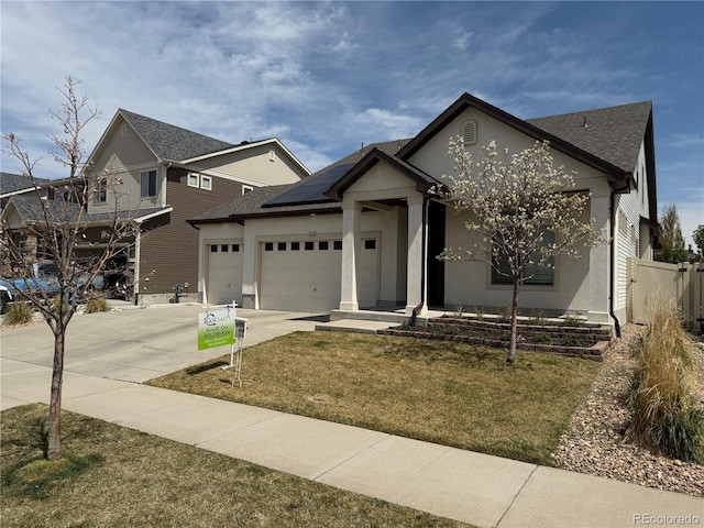5232 Truckee St, Denver, CO 80249 - ranch-style home featuring concrete driveway, a garage, stucco siding, roof mounted solar panels, and a front lawn