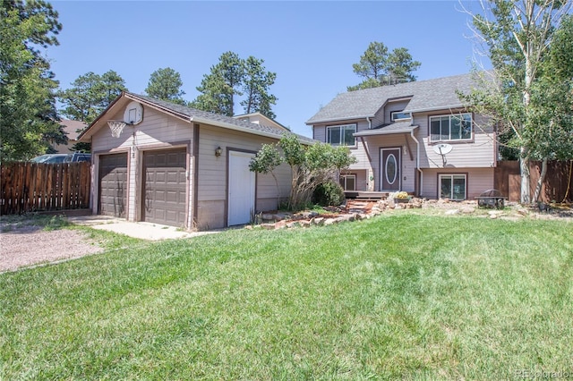 view of front of home with a garage, an outdoor structure, and a front yard