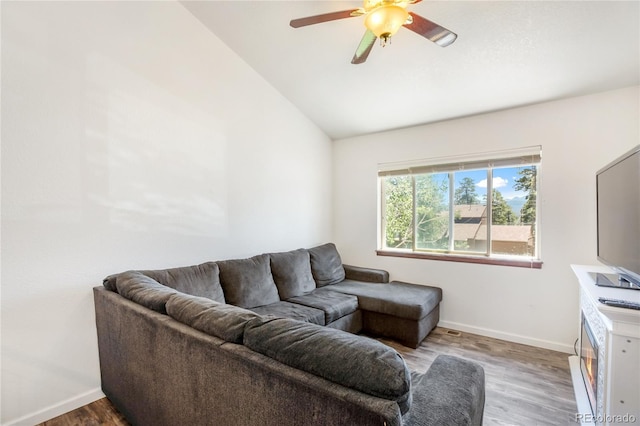 living room featuring lofted ceiling, light wood-type flooring, and ceiling fan