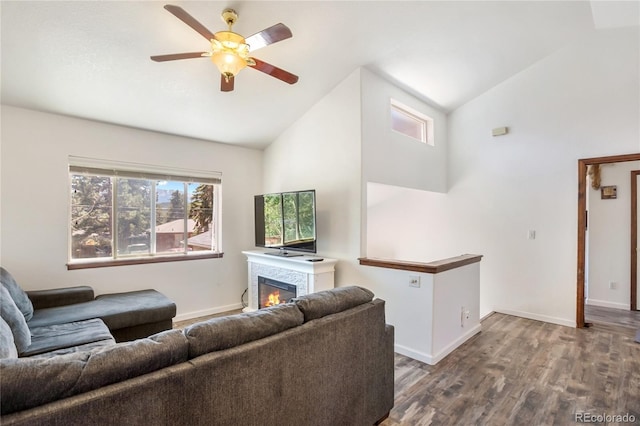 living room featuring dark hardwood / wood-style flooring, high vaulted ceiling, and ceiling fan