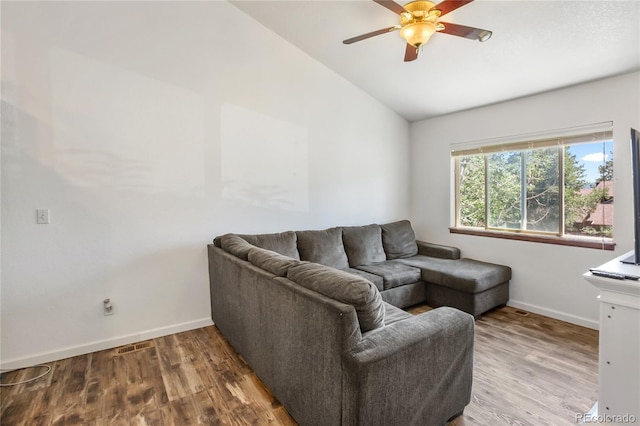 living room with ceiling fan, wood-type flooring, and vaulted ceiling