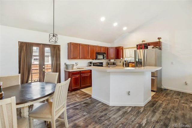 kitchen with hanging light fixtures, hardwood / wood-style floors, and an island with sink