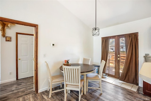 dining space with wood-type flooring, french doors, and lofted ceiling