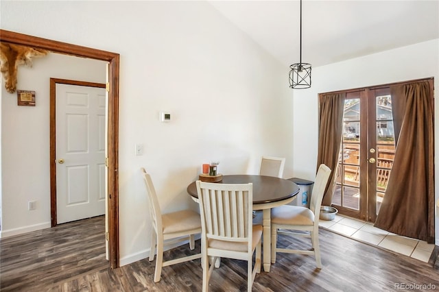 dining room with vaulted ceiling, french doors, and hardwood / wood-style floors