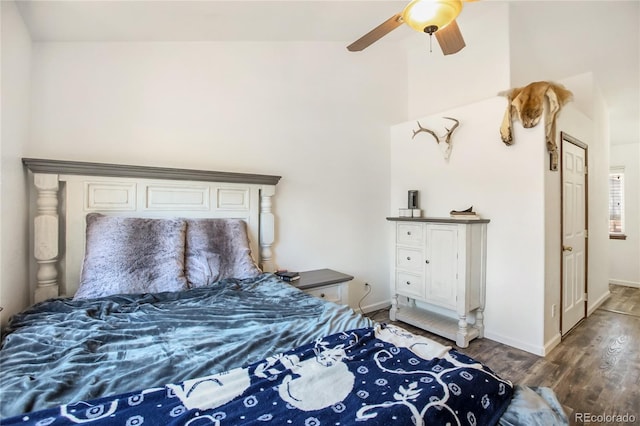 bedroom with ceiling fan, lofted ceiling, and hardwood / wood-style floors