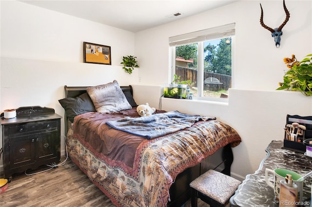 bedroom with wood-type flooring