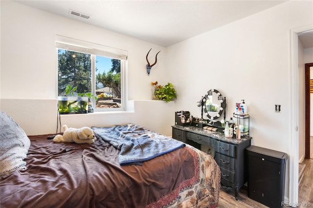 bedroom with light hardwood / wood-style floors