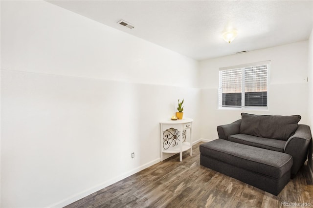 living area with hardwood / wood-style floors