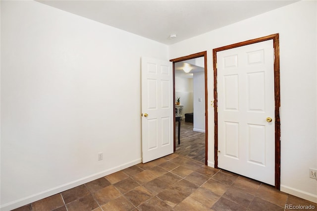 unfurnished bedroom with dark tile patterned floors