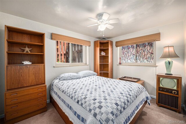 carpeted bedroom with baseboards and a ceiling fan