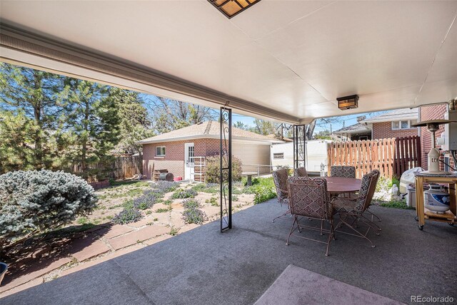 view of patio with a fenced backyard and outdoor dining space