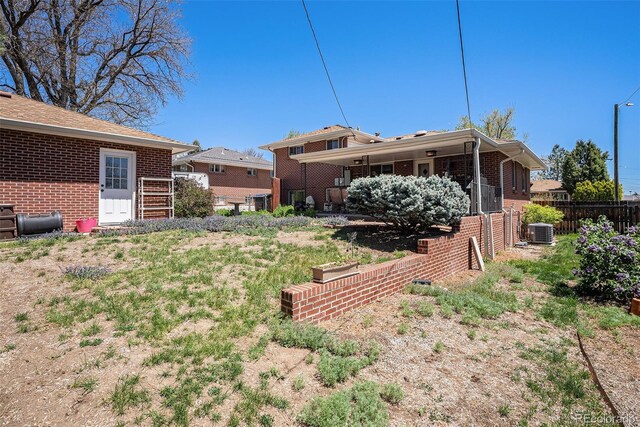 view of yard with fence and central AC