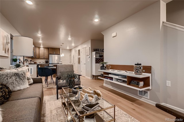 6309 N Hanover St, Denver, CO 80238 - living area featuring light wood finished floors, recessed lighting, and baseboards