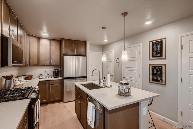 6309 N Hanover St, Denver, CO 80238 - kitchen with appliances with stainless steel finishes, a sink, recessed lighting, light countertops, and light wood finished floors