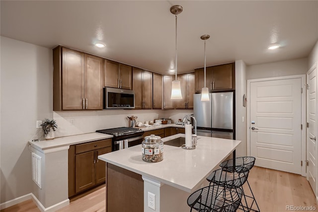 6309 N Hanover St, Denver, CO 80238 - kitchen featuring appliances with stainless steel finishes, a sink, light countertops, light wood finished floors, and recessed lighting