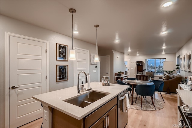 6309 N Hanover St, Denver, CO 80238 - kitchen with a sink, light wood finished floors, dishwasher, decorative light fixtures, and open floor plan