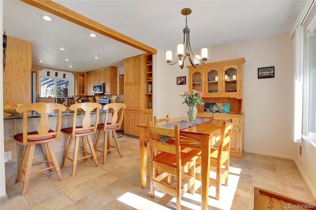 tiled dining area featuring a notable chandelier