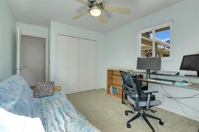 home office with ceiling fan and light carpet