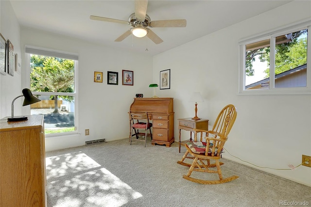 sitting room with ceiling fan and light carpet