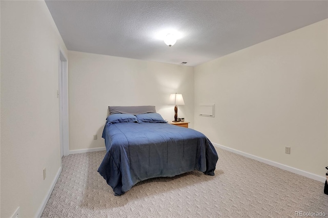 bedroom with a textured ceiling and carpet floors