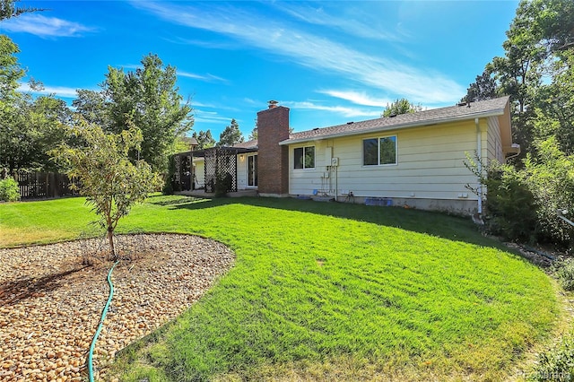 back of house with a lawn