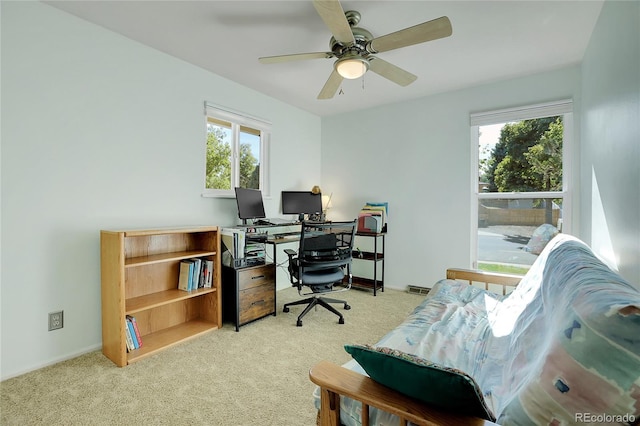 office space with light colored carpet and ceiling fan