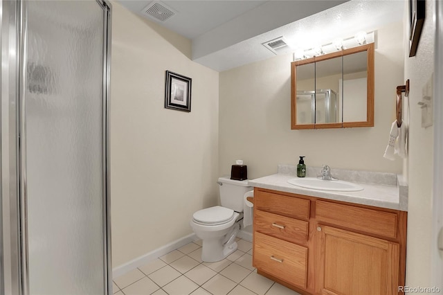 bathroom featuring tile patterned flooring, vanity, an enclosed shower, and toilet