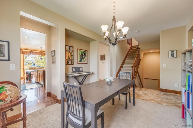 dining area featuring a notable chandelier and light hardwood / wood-style flooring