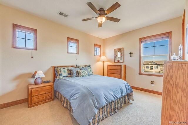 bedroom featuring ceiling fan and light carpet