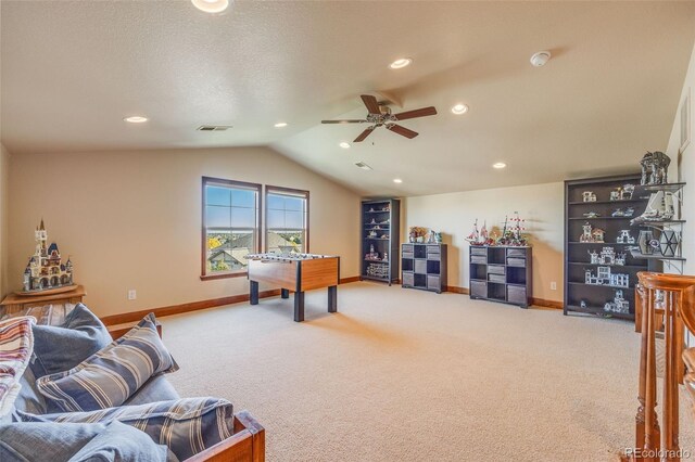 game room featuring vaulted ceiling, carpet flooring, and ceiling fan