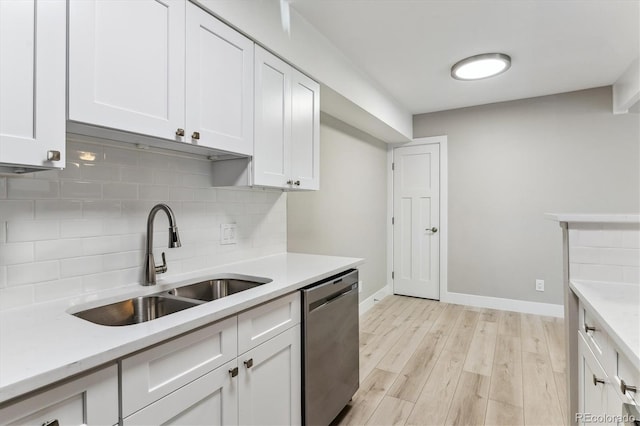 381 S Ames St Unit E104, Lakewood, CO 80226 - kitchen with dishwasher, light countertops, backsplash, and white cabinets