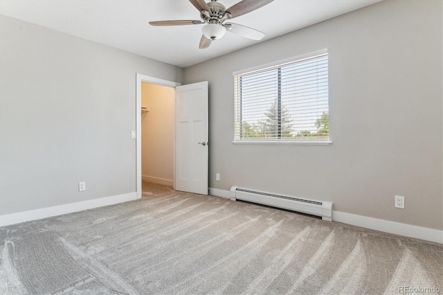 381 S Ames St Unit E104, Lakewood, CO 80226 - unfurnished bedroom with a baseboard heating unit, carpet, a spacious closet, and ceiling fan