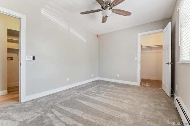 381 S Ames St Unit E104, Lakewood, CO 80226 - unfurnished bedroom with a baseboard heating unit, carpet flooring, a walk in closet, and a closet